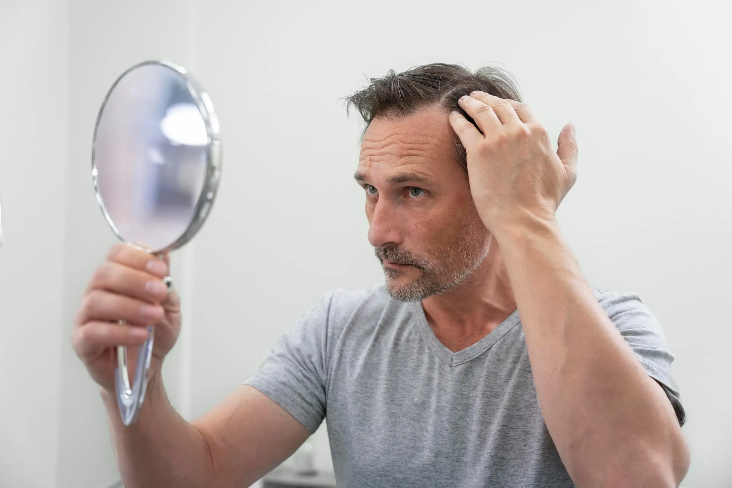 Diagram showing how DHT affects hair follicles and causes male pattern baldness, explained by DSI Hair dermatologists in Algonquin, Illinois